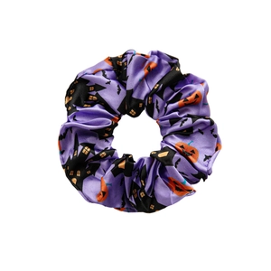 Halloween purple satin scrunchie with pumpkin and bat prints for festive hair styling