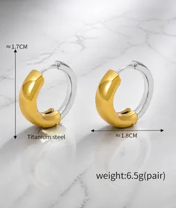 Detail of two-tone C-shape hoop earrings in titanium steel with 1.7cm dimensions