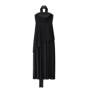 Detail of elegant black halter dress featuring asymmetrical mesh splice and side slit hem