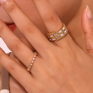 Detail of 18K gold plated rings with micro-set zircons on hand, featuring weave texture