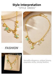 Detailed macro view of gold sea turtle, starfish and scallop pendants on chunky chain