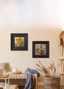 Detail of vintage black embossed photo frames with floral art on a beige wall
