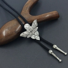 Detailed view of Bolo tie featuring black braided cord and a moth with moon-star metal pendant