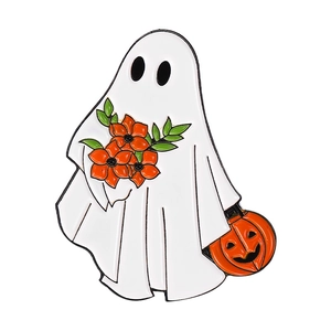 Close-up of cute ghost enamel pin holding a pumpkin basket and orange flower bouquet
