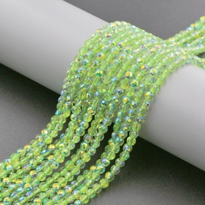 Detailed view of 4mm faceted glass beads in neon green with rainbow aurora finish
