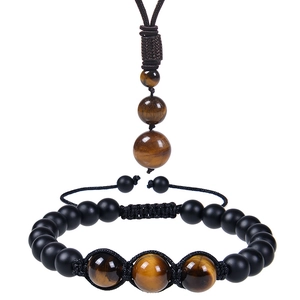 Detail view of tiger eye stone necklace and adjustable black beaded bracelet set