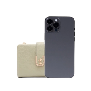 Mini sage green leather wallet with tulip metal clasp next to a phone for scale
