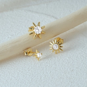 Macro shot of gold-plated S925 silver sunflower stud earrings with clear zircon stones