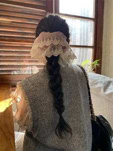 Detailed back view of pink mesh lace scrunchie styled in a ponytail for elegant look