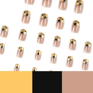Gold French tip press-on nails with black star design on nude pink square fake nails