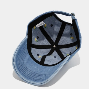 Detail showing 100% cotton denim fabric with interior lining and adjustable metal buckle