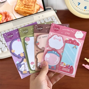 Close-up of four colorful cartoon sticky note pads in purple, green, brown, and pink