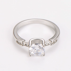 Macro detail of silver stainless steel ring with four-prong set cubic zirconia and side stones