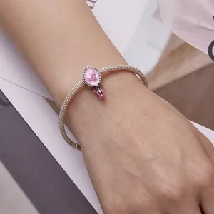 Pink fairy princess style silver bracelet featuring butterfly charms on a model's wrist