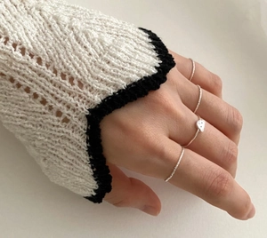 Detailed view of four minimalist 925 silver rings including a cute bear charm band