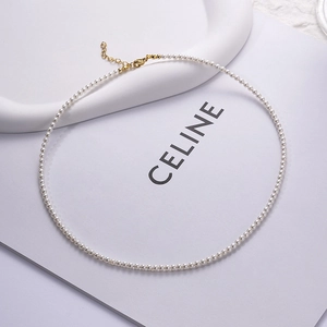 Macro view of minimalist white pearl necklace with golden adjustable extension chain