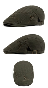 Detail of olive green vintage flat cap with letter embroidery and side metal buckle