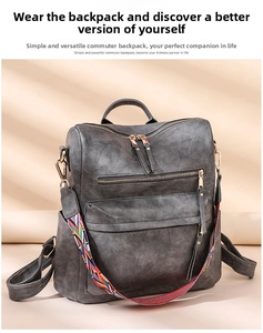 Detail of dark gray faux leather backpack featuring a bohemian woven shoulder strap