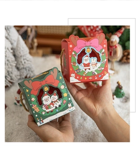 Close-up of red and green Christmas gift boxes with cutout Santa and reindeer designs