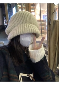 Detailed knit texture of a beige oversized slouchy beanie for women in a street setting