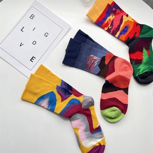 Detailed flat lay of three cotton socks with abstract colorful jacquard patterns