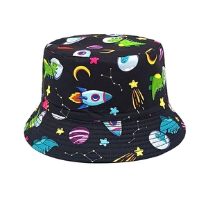 Close-up of black kids bucket hat featuring cartoon dinosaur astronauts and space prints