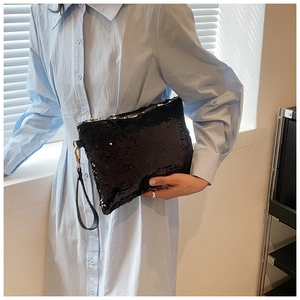 Elegant black sequin clutch bag with golden hardware and leather strap for evening parties