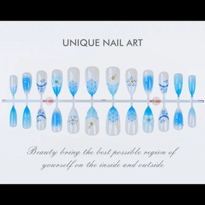 Detailed view of blue gradient press-on nails with 3D floral and pearl decorations
