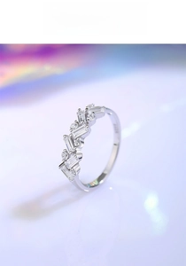 Macro detail of S925 sterling silver ring with alternating rectangular and round crystals