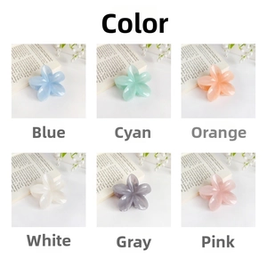 Close-up of colorful flower hair claws in a variety of macaron shades on a desk