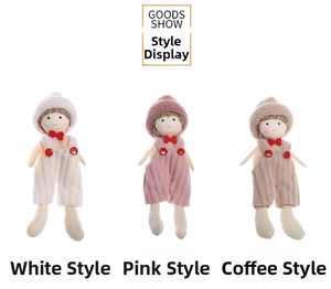 Detailed view of Christmas knit doll pendants in white, pink and brown stripe overalls