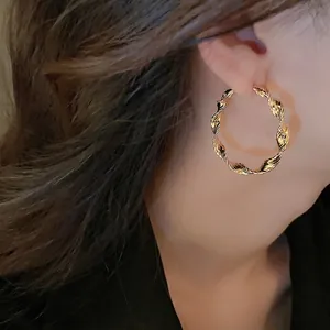 Minimalist gold-plated twisted hoop earrings for women with a textured spiral design