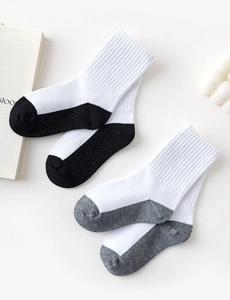 Close-up of black and grey knit cotton mid-calf socks displayed on a white background