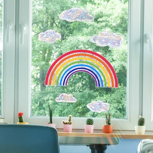 Rainbow and cloud static window decals displaying colorful light patterns in a home setting
