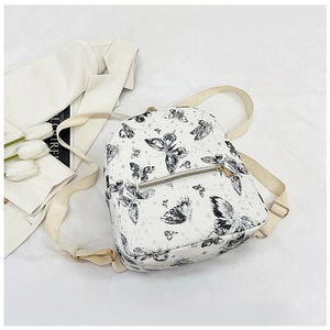 Close-up of white PU leather butterfly backpack with stylish black sketch print detail