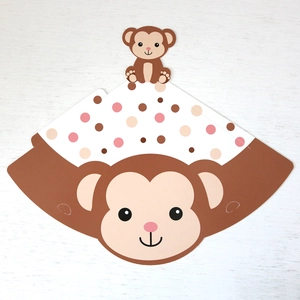 Detail of cartoon monkey party decoration made of paper with pink and brown polka dots