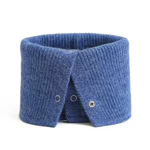Detail of blue knitted neck warmer featuring snap button closure and ribbed texture