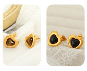 Detailed view of heart-shaped stud earrings featuring tiger eye and black stones