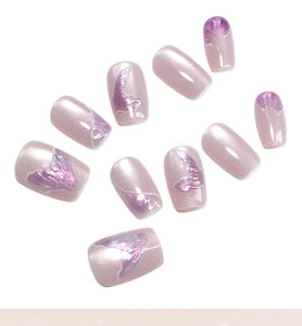 Detail of 10-piece pink mermaid tail press-on nails with pearl finish and laser gradients