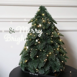 Outdoor waterproof firefly string lights on a decorated Christmas tree with warm LED glow
