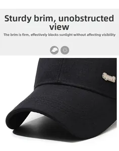 Detail of black baseball cap brim with silver Sport logo and durable twill fabric texture