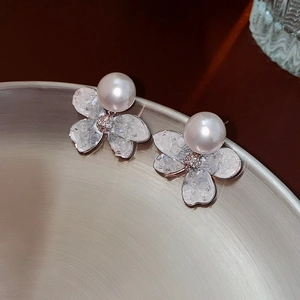 Elegant silver flower earrings featuring white pearls and shimmering crystal petals