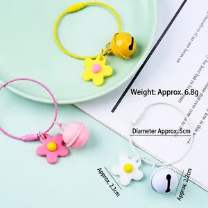 Creative DIY soft rubber flower keychains with bells in pink, yellow, and white
