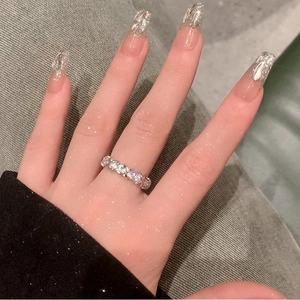Close-up of minimalist geometric silver ring with sparkling zircon stones on a model