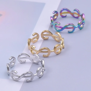 Detailed close-up of S-shaped open rings in silver, gold, and rainbow metallic finishes