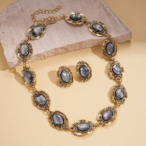 Vintage gold oval resin pendant necklace and earrings set with iridescent grey stone inlay