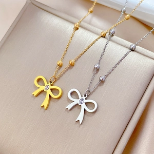 Minimalist titanium steel bow necklace with zircon in gold and silver finish options