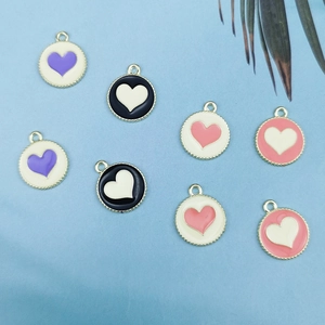 Detailed view of colorful heart-shaped drip oil alloy pendants for DIY jewelry making