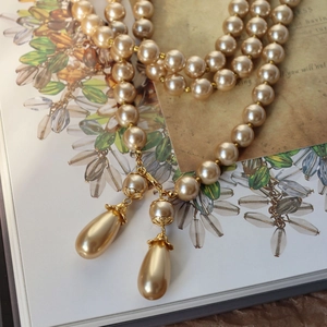 Vintage Baroque pearl necklace with champagne drop pendants on a classic book