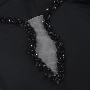 Detail of V-neckline with shimmering sequins and sheer mesh on black fishtail dress